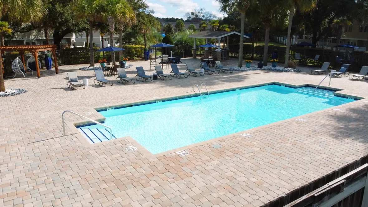 An exquisite view of the resort-style pool with shimmering water and a spacious pool deck. 