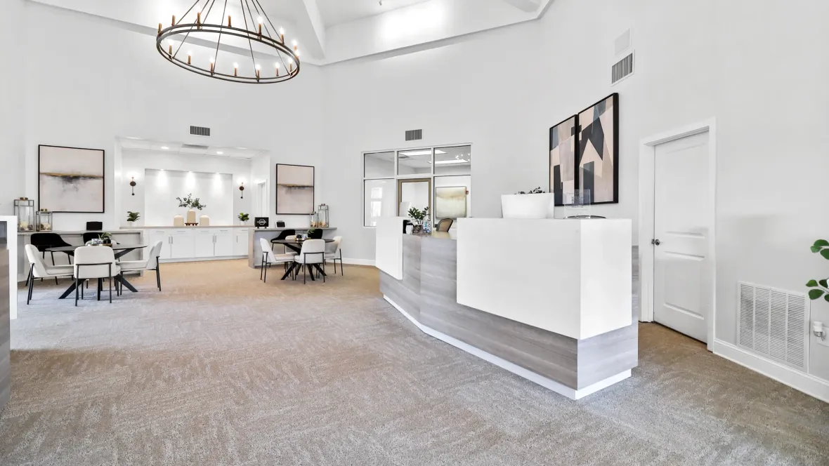 A welcoming leasing office with comfortable seating and a central leasing desk