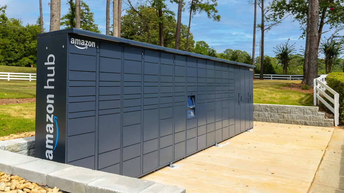 A wall of various-sized hub lockers for parcel delivery, conveniently placed outside for residents' 24/7 access to their Amazon deliveries.