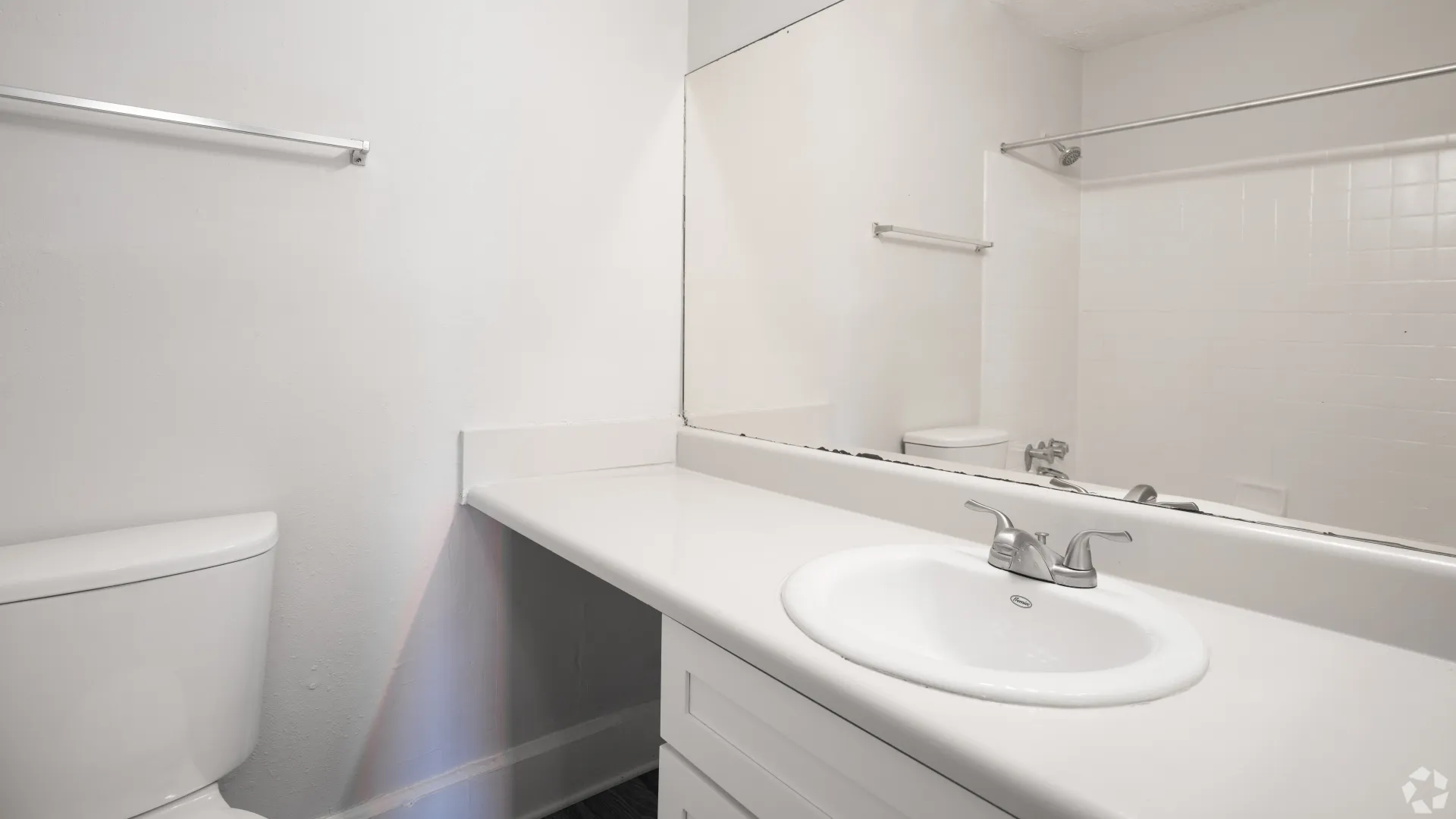 Guest bathroom with a large mirror, ample countertop space, and bathtub in The Whitlock floor plan.