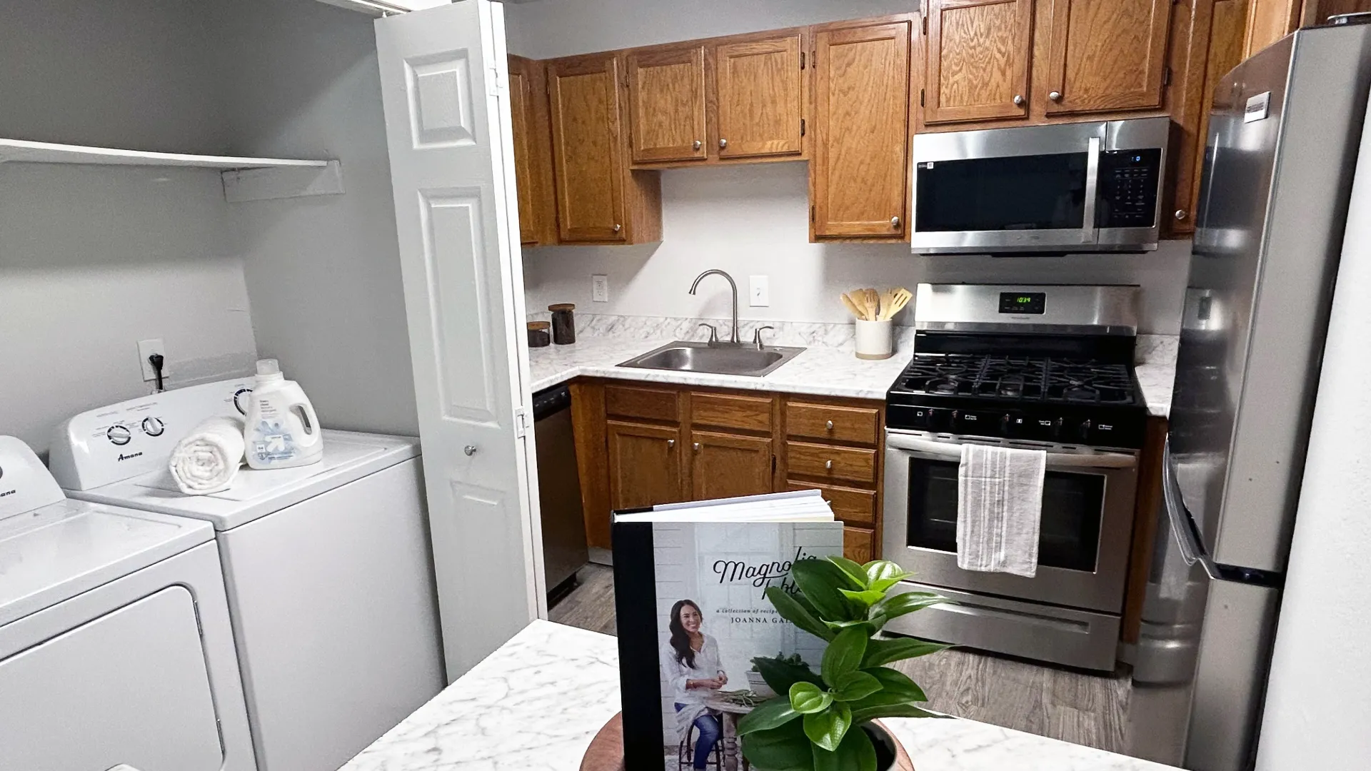 A kitchen with attached laundry space and ample counterspace