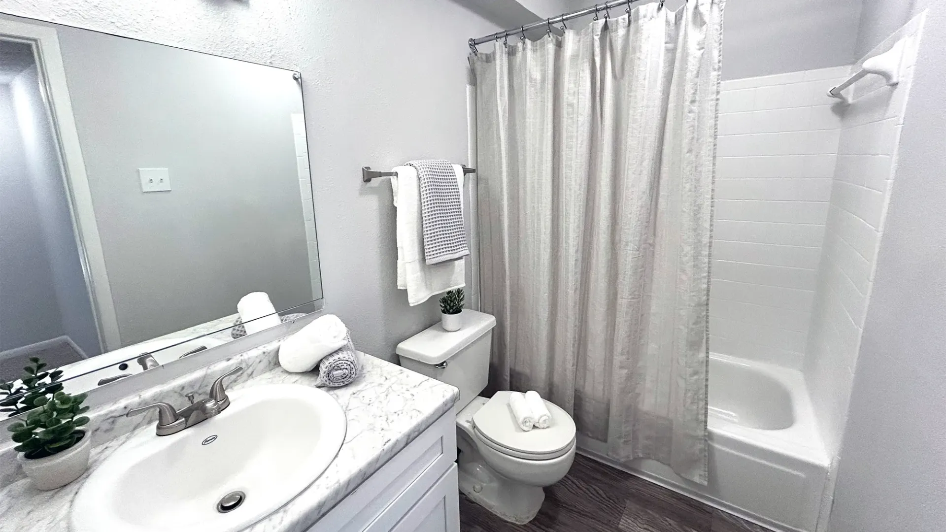 A bathroom with upgraded features, garden tub, and huge mirror