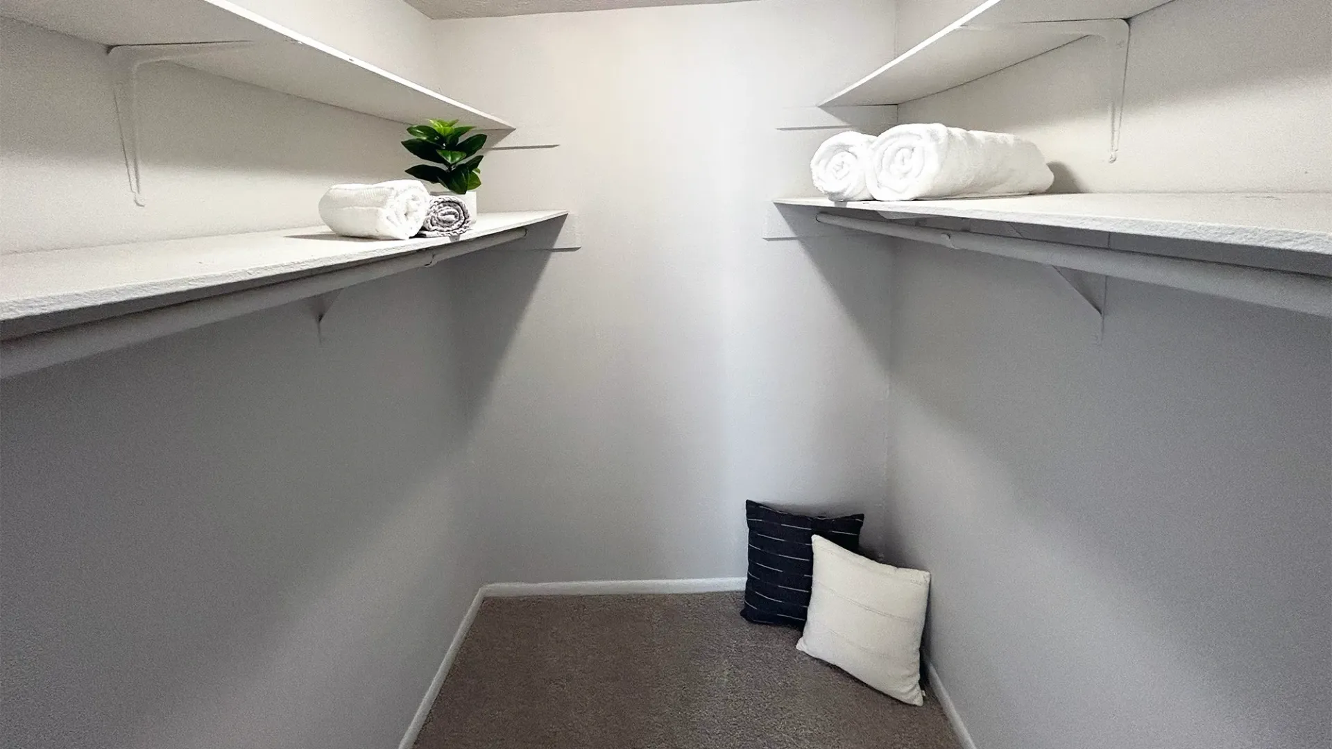 A large closet with wall-length shelves for storage