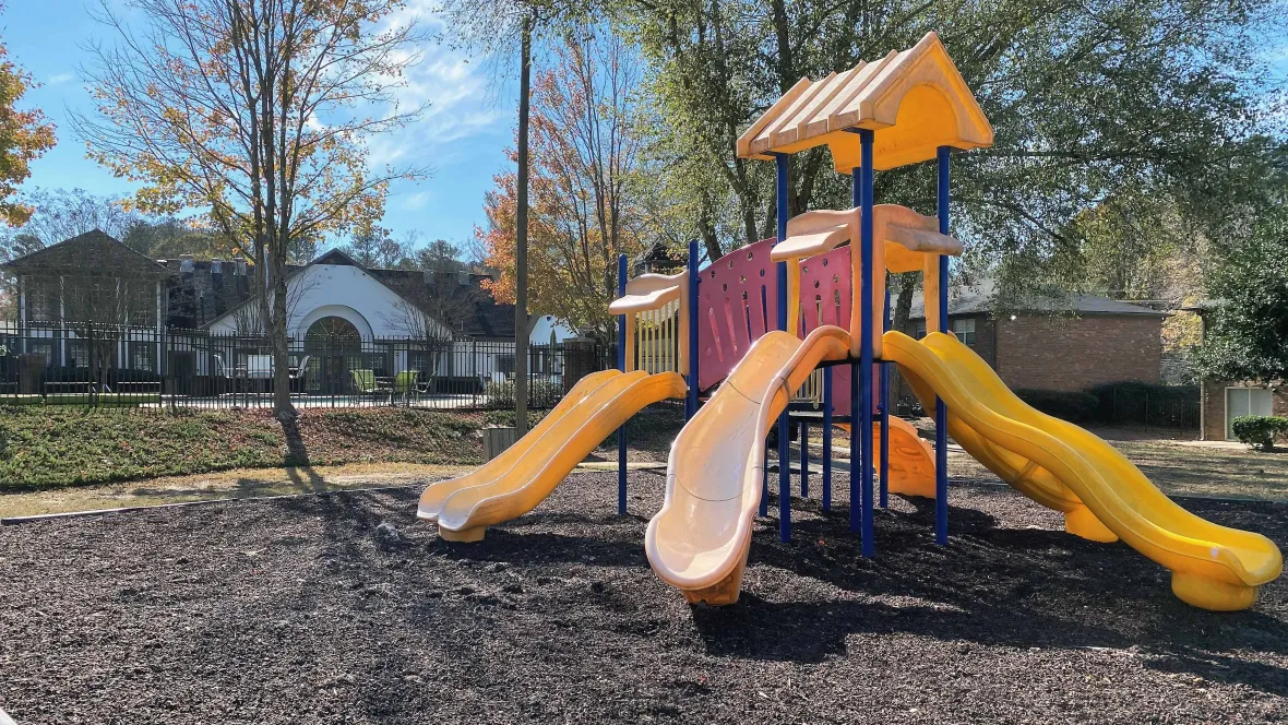 A well maintained playground and surrounding grounds, offering a delightful outdoor space for children and families to enjoy right in their backyard.