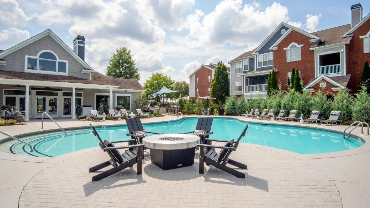 Fire pit on the sundeck in front of our resort-style pool surrounded by Adirondak chairs.