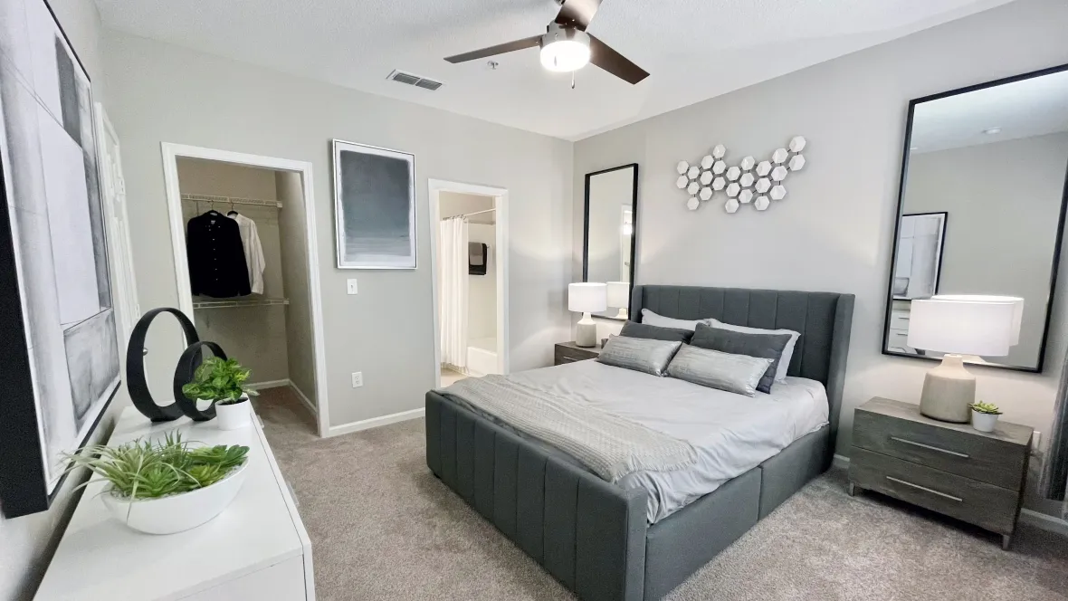 Master bedroom with plush carpeting, personal linen closet, and private bathroom access.