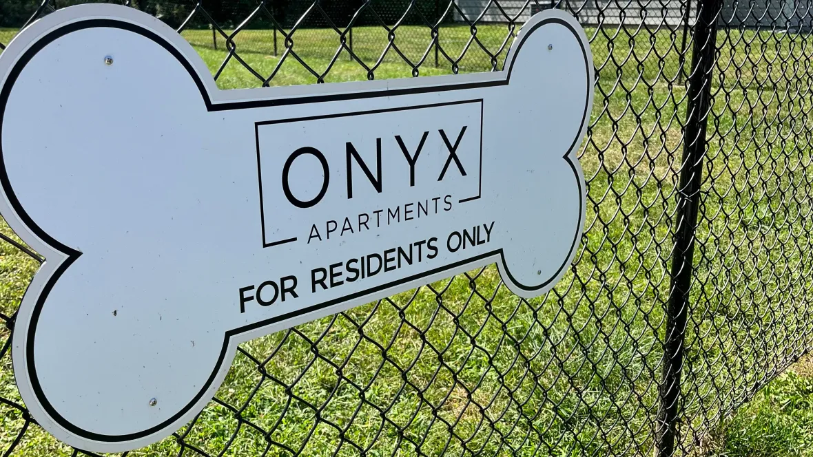 A bone-shaped dog park sign. 