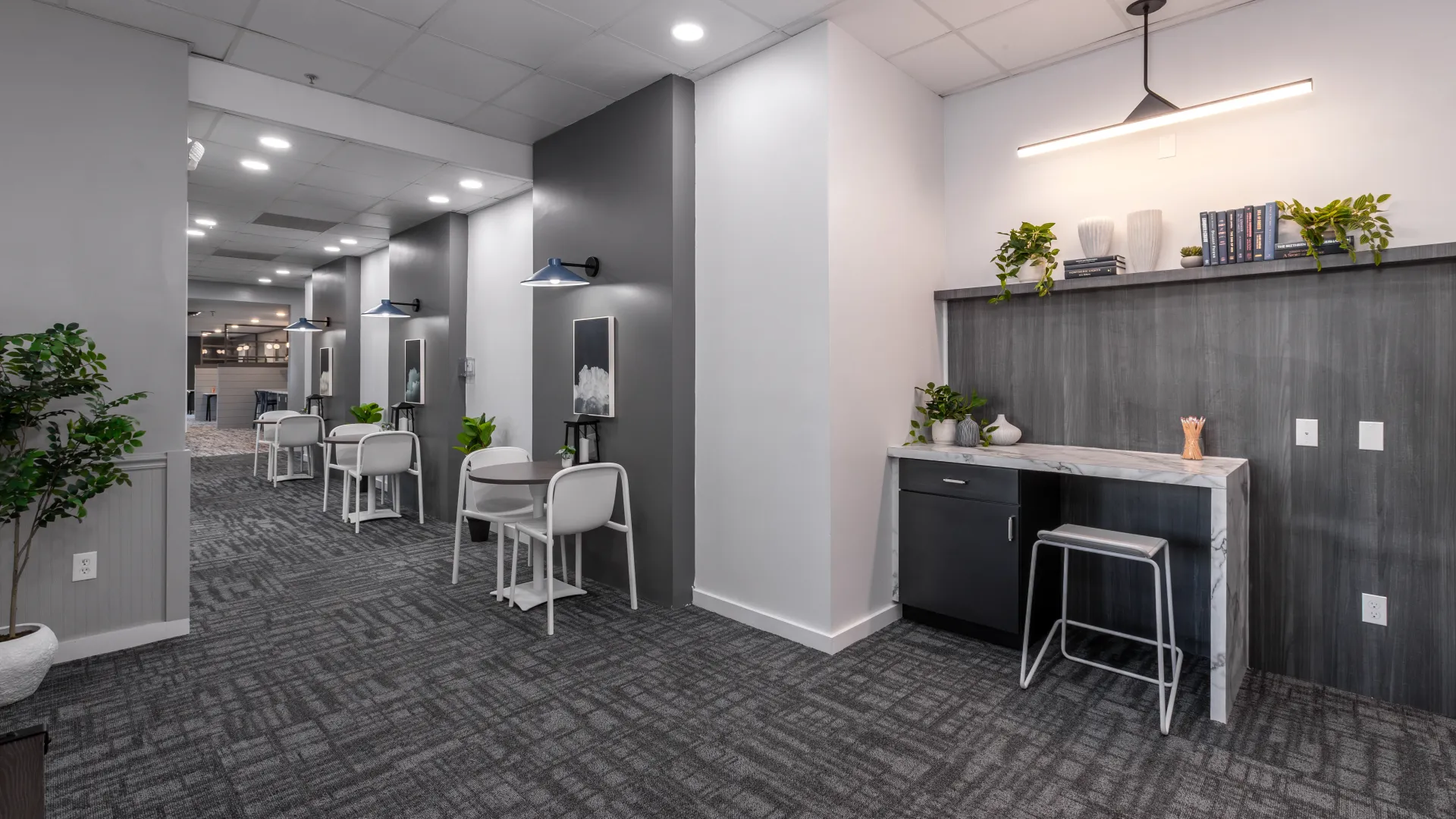 Modern study lounge featuring sleek workstations, comfortable seating, ample lighting, and contemporary decor, ideal for students to work and collaborate.