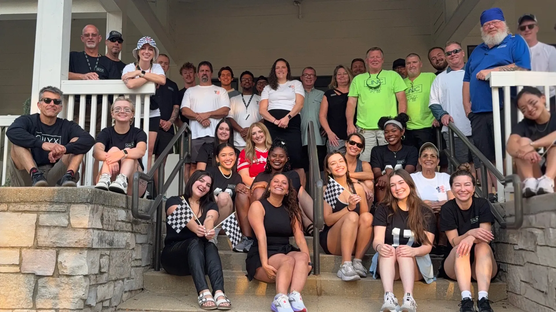 The Linc and Onyx staff smiling and posing on the front steps during move-in day.
