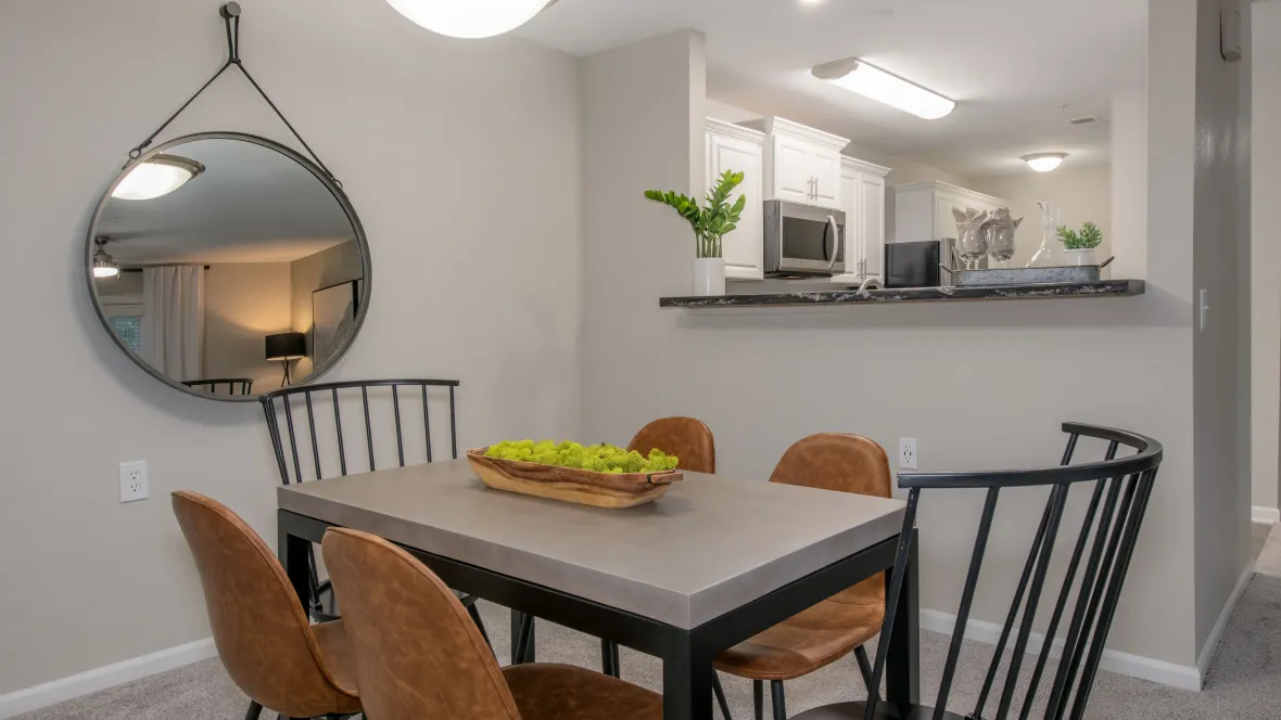 A refined dining area with a large table, seamlessly connecting to the kitchen
