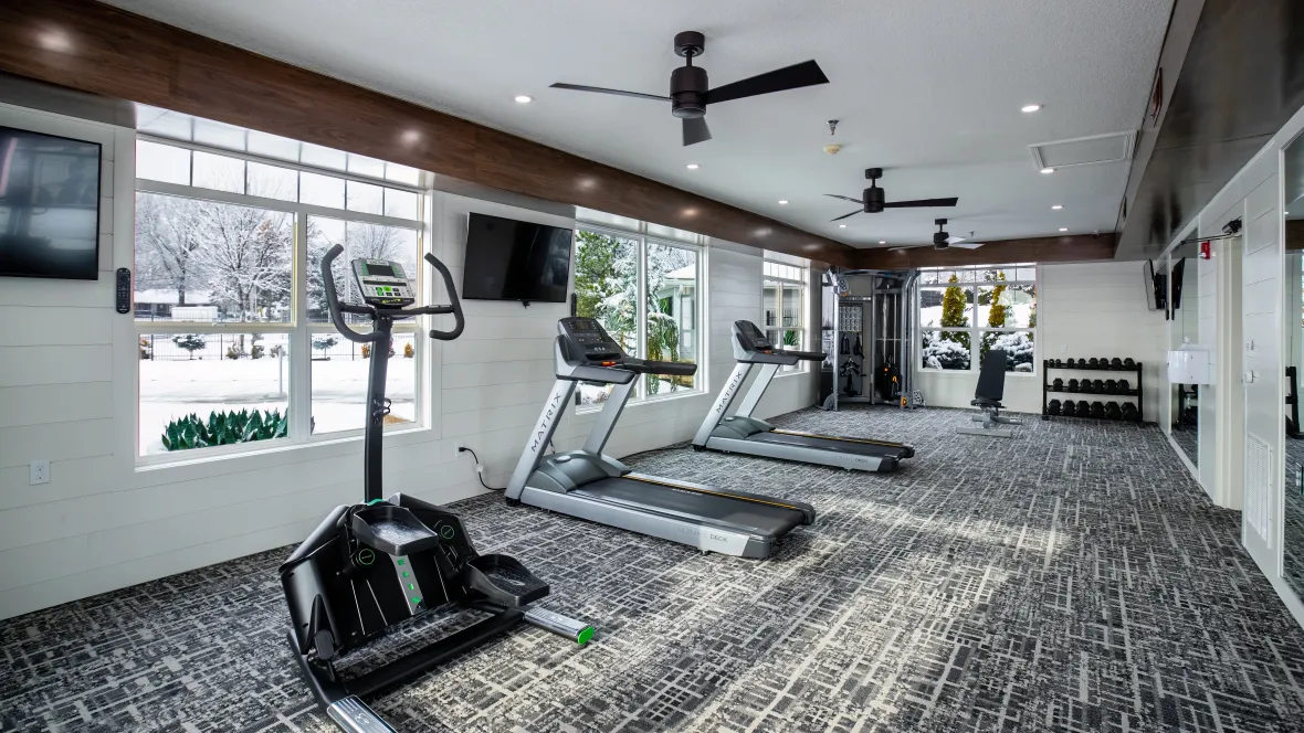 A spacious fitness center filled with modern workout gear