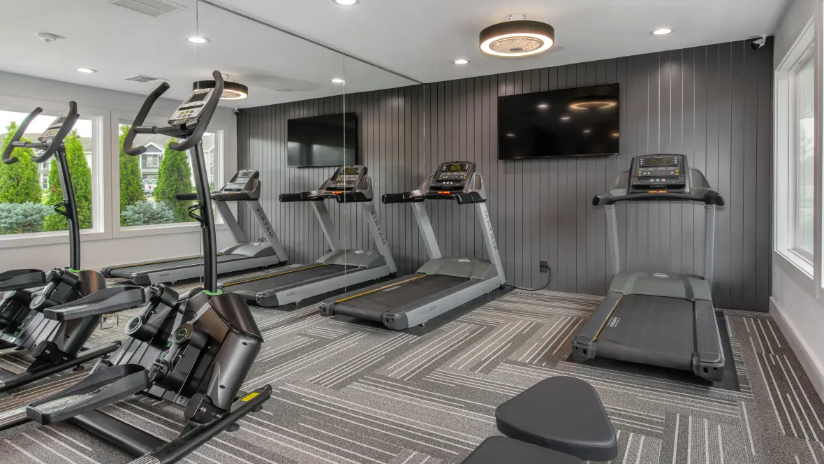A captivating space with matching black wall paneling and a range of exercise equipment.