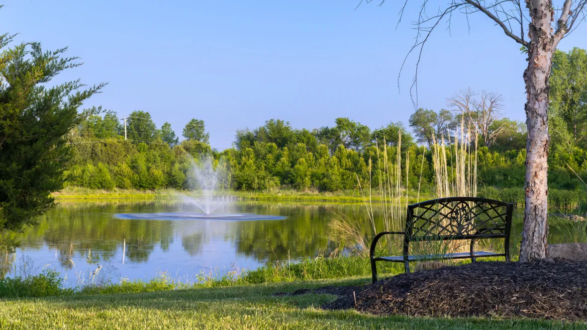 A bench overlooking the lake with fountain