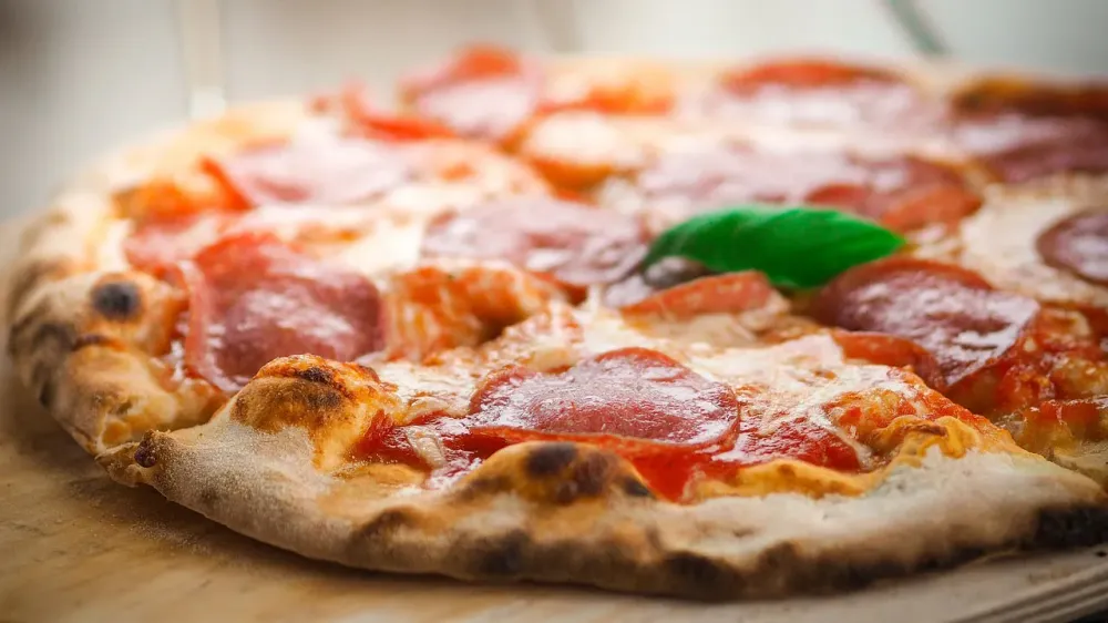 Close-up of a freshly baked pepperoni pizza with melted cheese.