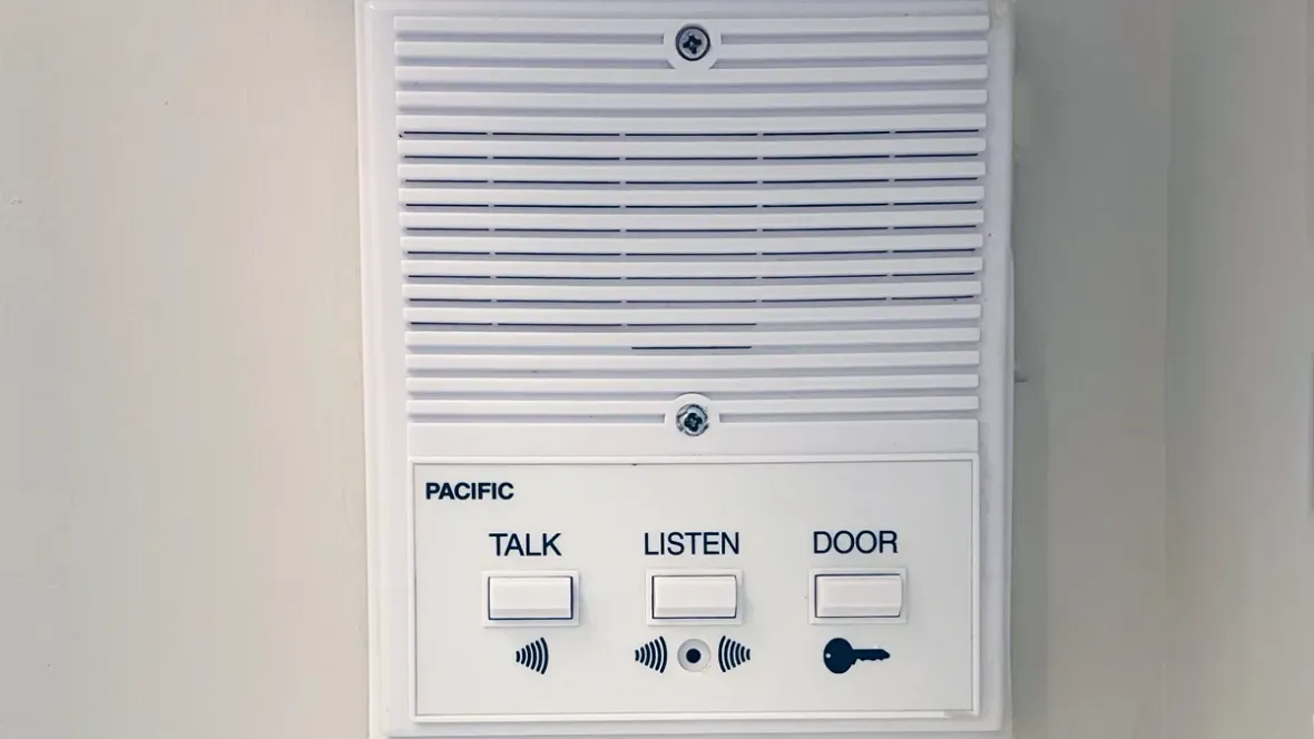 The in-apartment intercom system with buttons to “Talk,” “Listen,” and open “Door.”