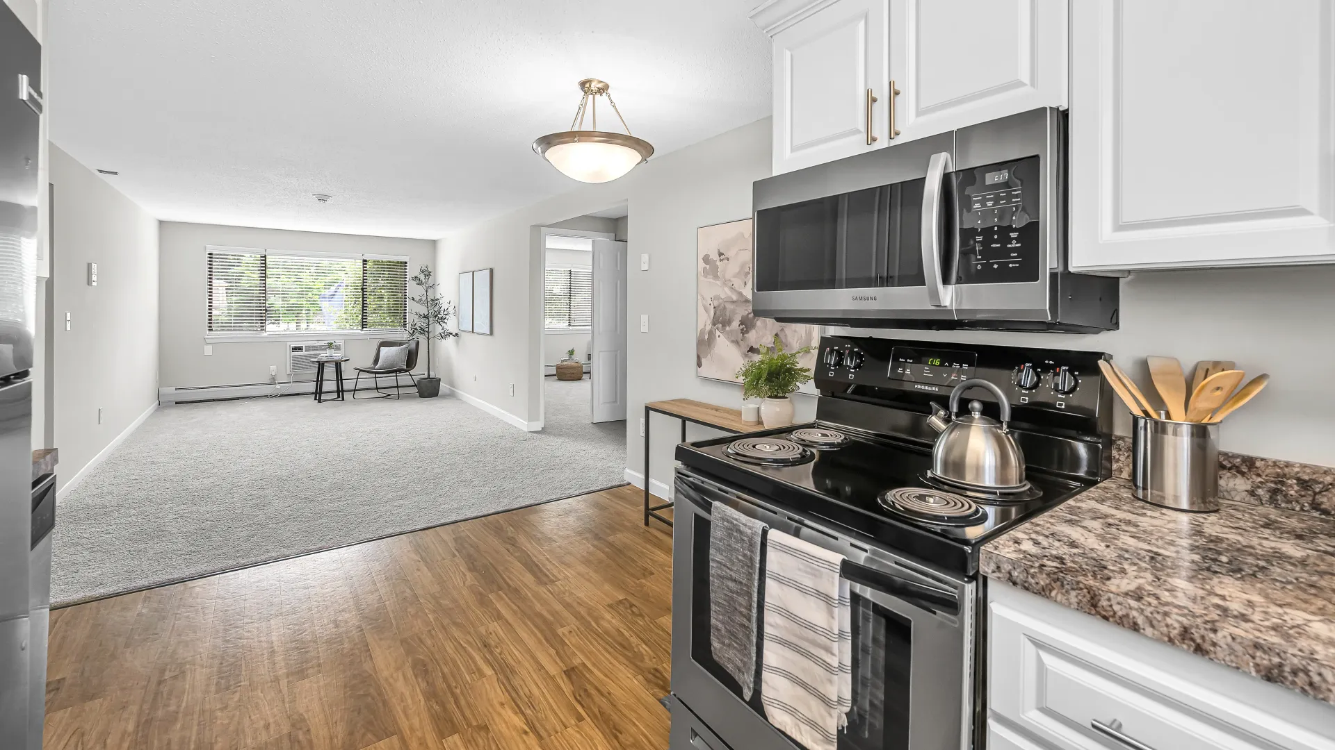 A sleek and stylish kitchen with a full set of stainless-steel appliances, offering a spacious countertop and a separate dining area.
