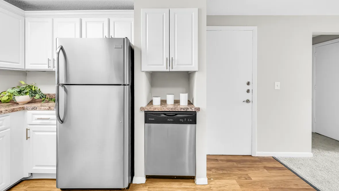 A modern and inviting kitchen equipped with a suite of stainless steel appliances, spacious countertops, and ample cabinetry.