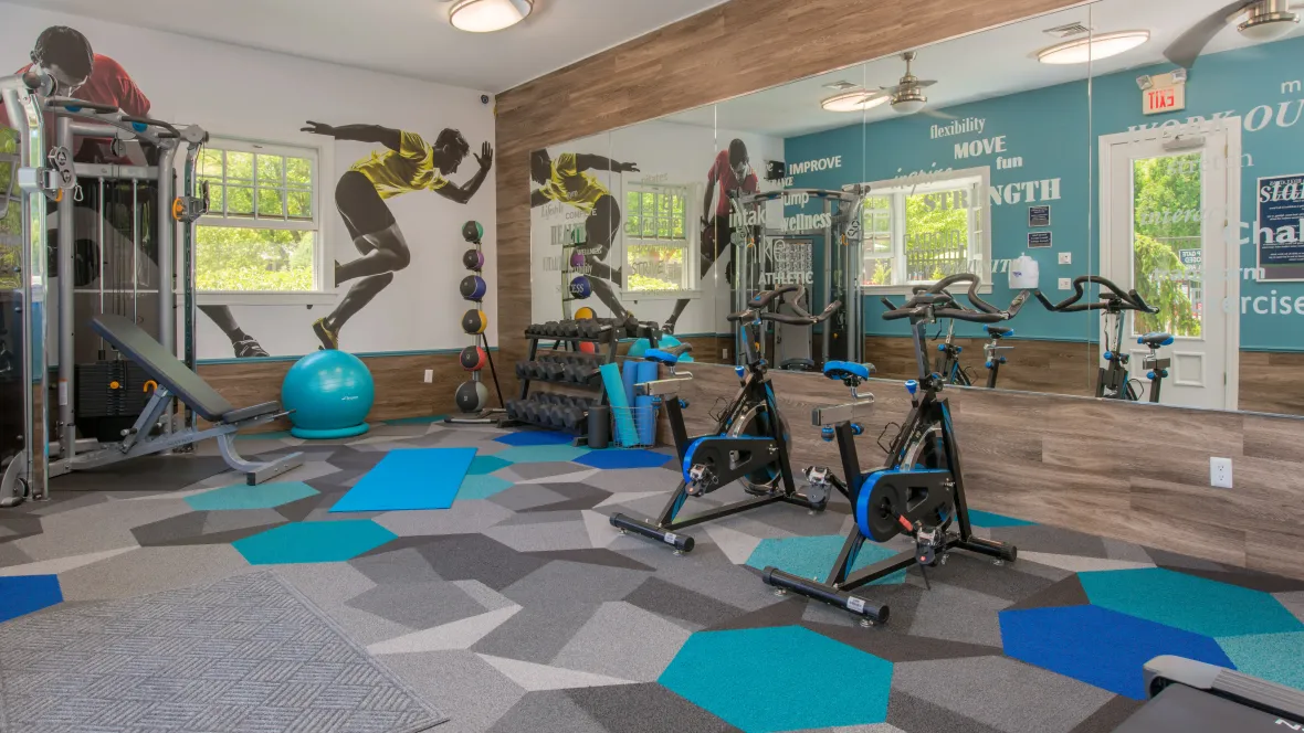 A vibrant, fully-equipped fitness center with a variety of modern workout equipment.