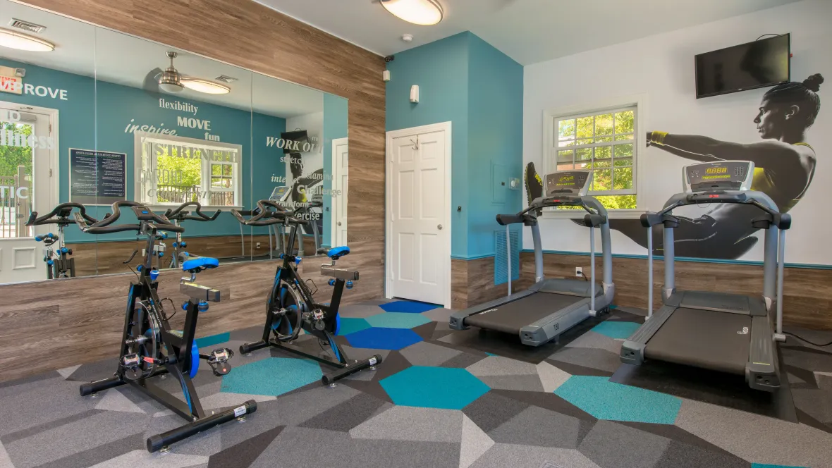 A 24/7 fitness center equipped with contemporary exercise machines.