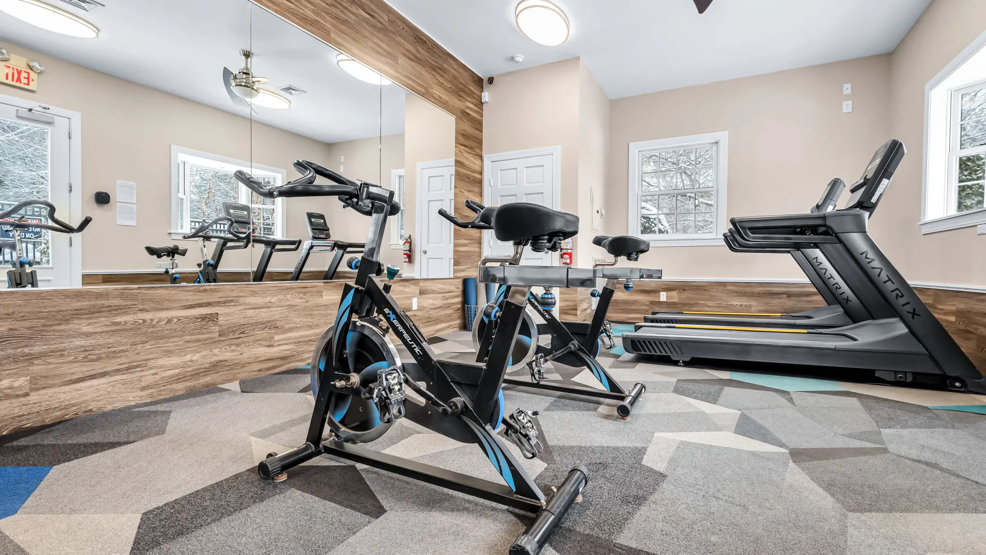 Fitness center featuring exercise bicycles and treadmills