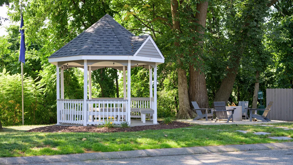 A relaxing oasis with spacious standalone gazebo and Adirondack seating encircling a dancing flame at the firepit. 