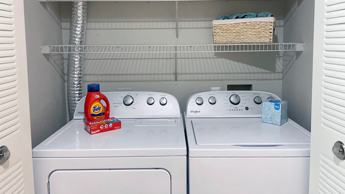 Full-size washer and dryer in a cozy laundry closet for your ultimate convenience.