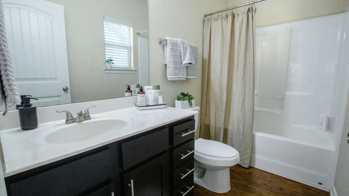 A private bathroom with garden tub and ample storage space under the sink.