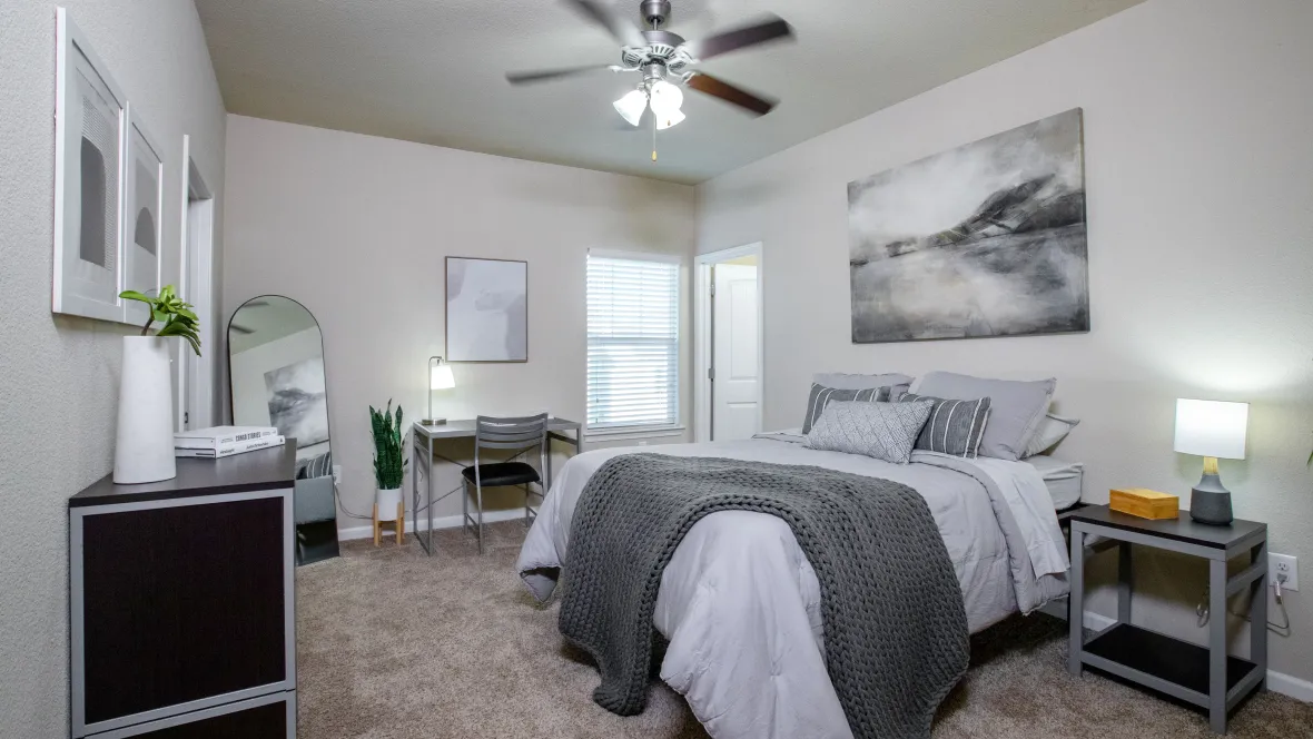 A large bedroom with a built-in, multi-speed ceiling fan.