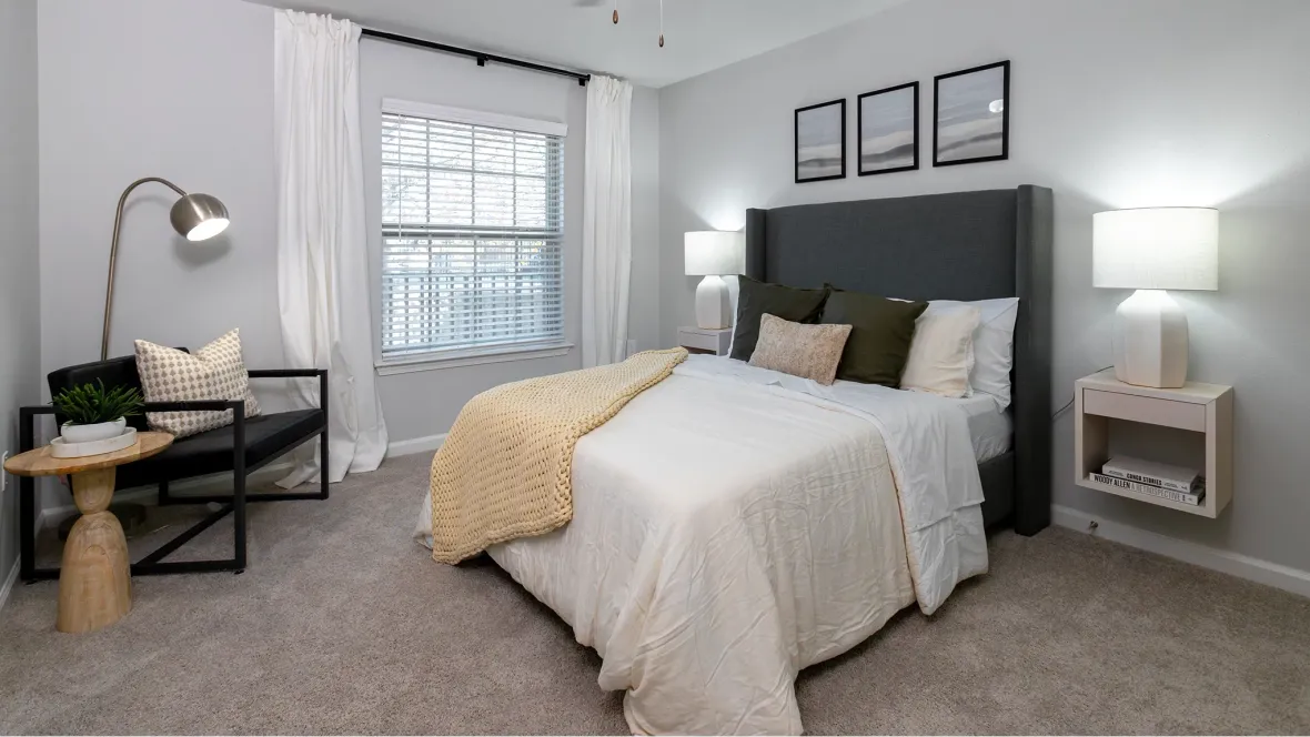 An extravagant master bedroom boasting spaciousness, fit for a king-size bed and outfitted with a contemporary lighted ceiling fan, exuding serene luxury.