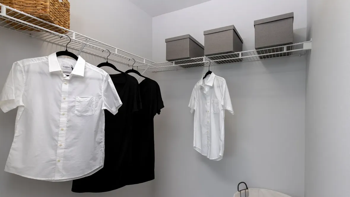 An expansive walk-in closet equipped with carefully planned shelving for precise organization of your wardrobe.
