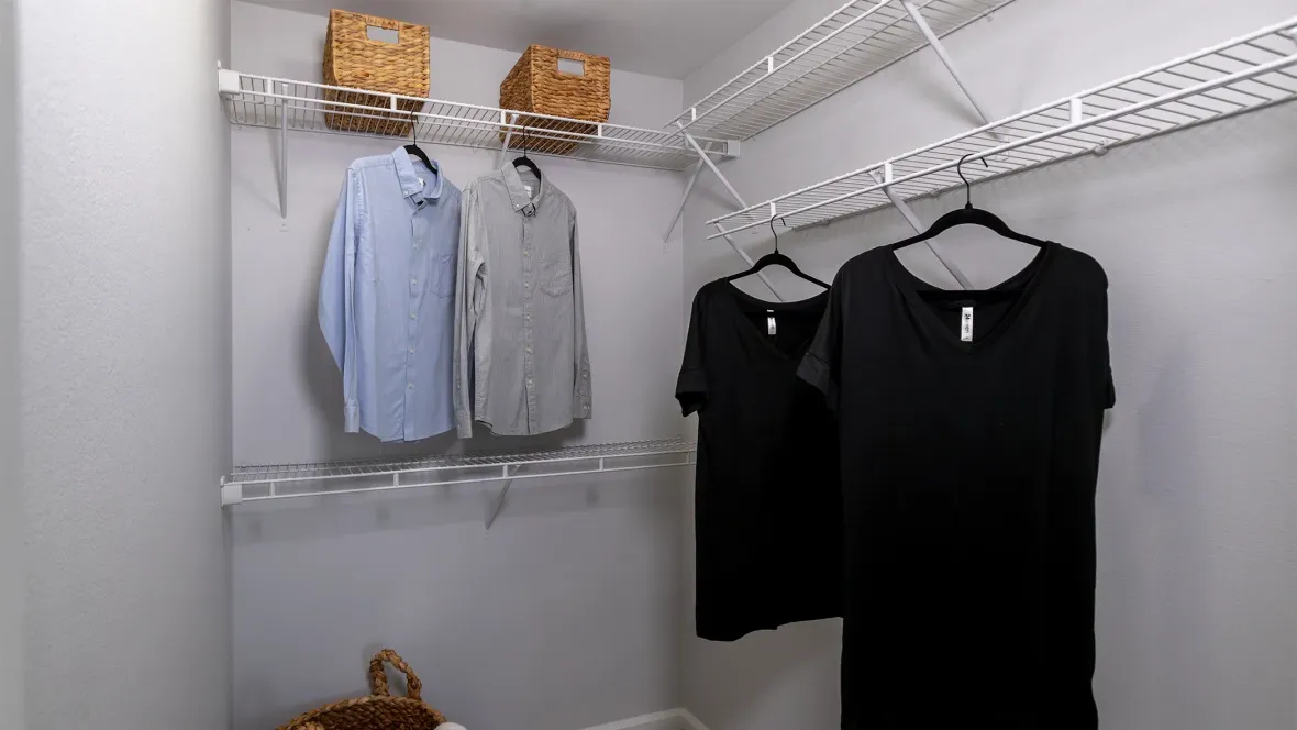 An oversized closet featuring a tailored shelving system for closes, shoes, or accessories.