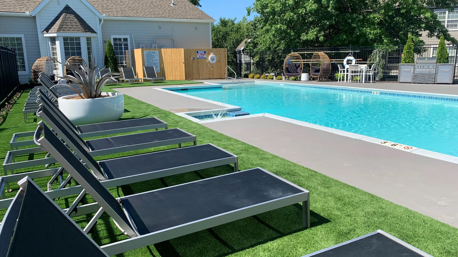 Glistening rectangular-shaped pool with a row of sun loungers