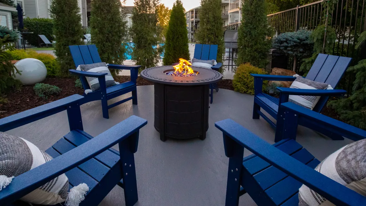 An up-close view of our firepit surrounded with Adirondack chairs.