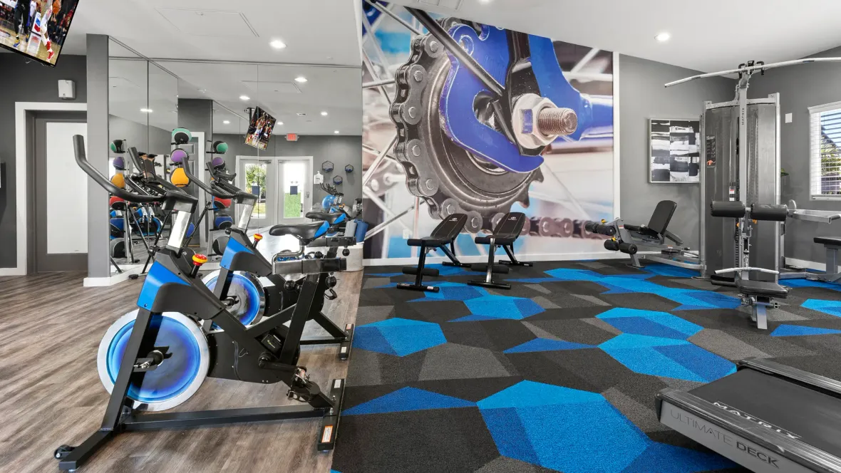 Two spinning bikes in the resident gym facing a wall of exercise mirrors offer residents an alternative exercise option to motivate and inspire.