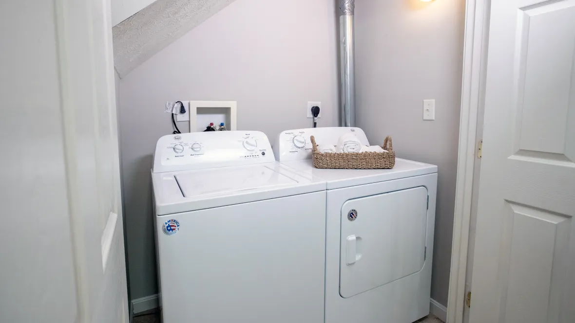 Contemporary washer and dryer appliance set conveniently located in apartment home for the utmost convenience.