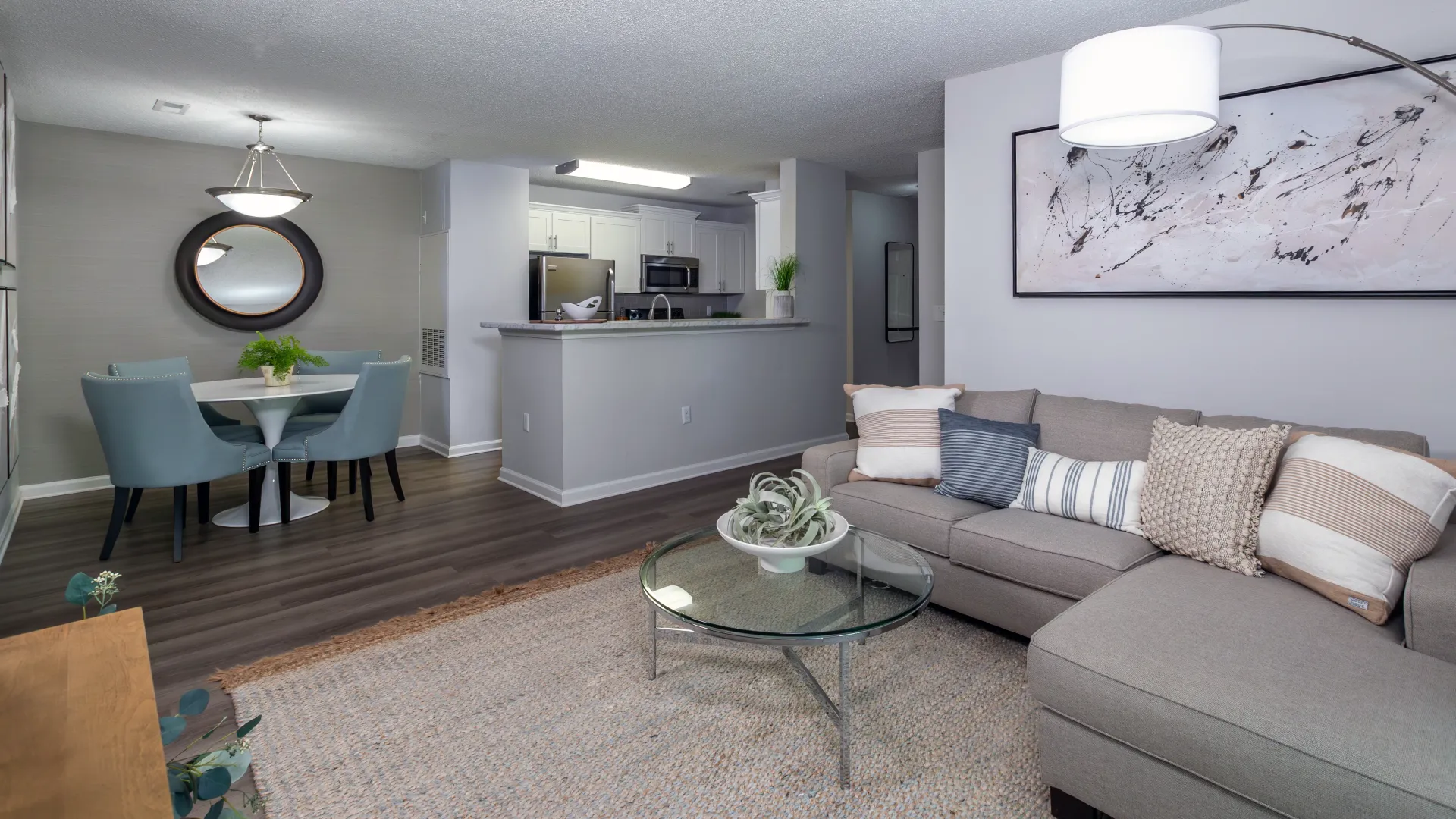 The living room, with view of the dining room and kitchen across the room, emphasizing the open-concept layout.