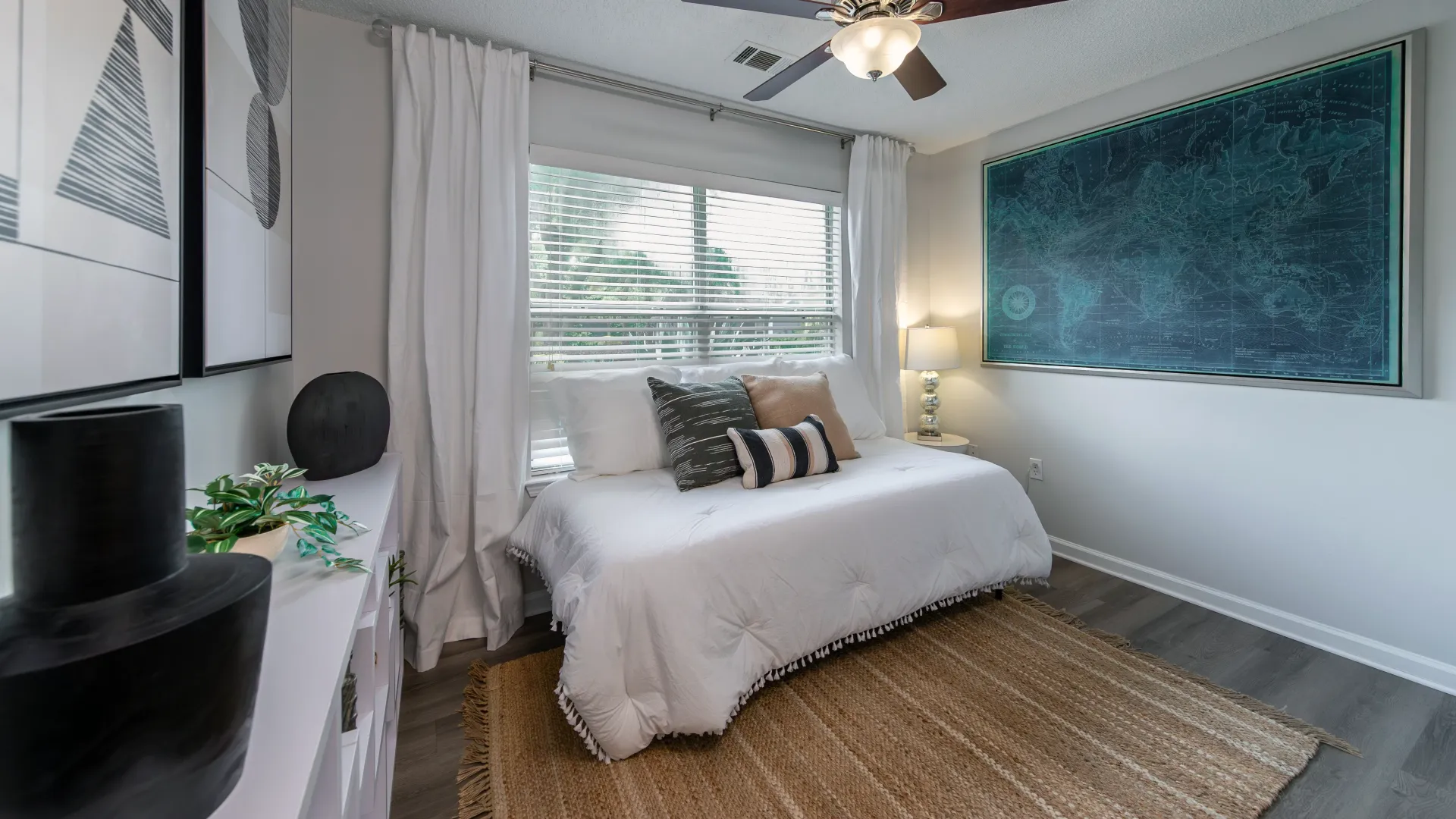 Spacious bedroom with wood-style flooring