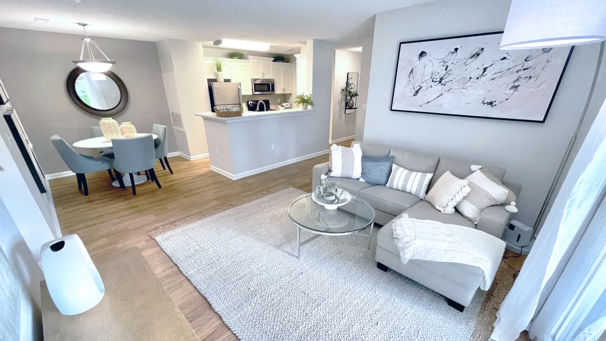 Wide-angle view of the open concept living room at Emerson Isles, showcasing the seamless connection to the dining and kitchen areas, creating a spacious and inviting atmosphere.