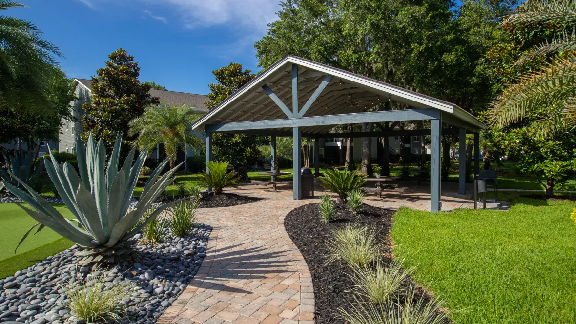 Exterior view of the pavilion at Emerson Isles, featuring a paved pathway leading to a serene and communal space for residents.