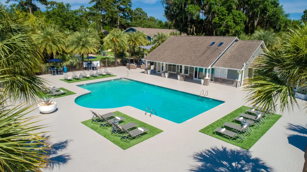 An aerial view of the pool deck, surrounded by loungers on patches of astroturf.