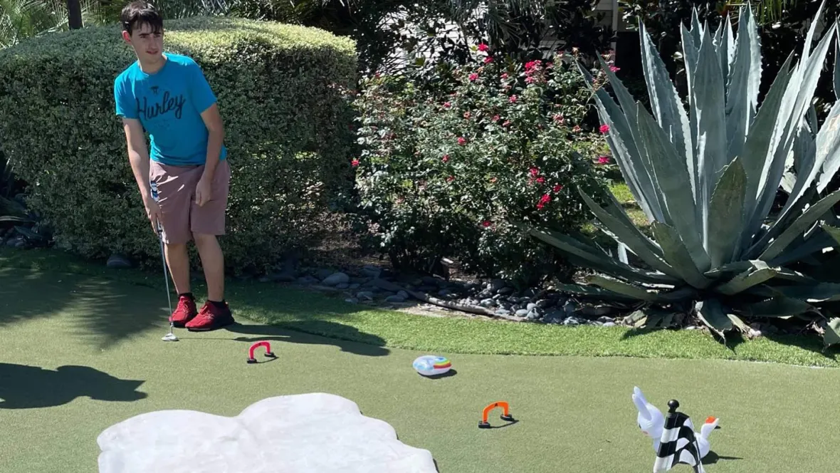 A resident getting ready to putt in our putt putt competition on our putting green.