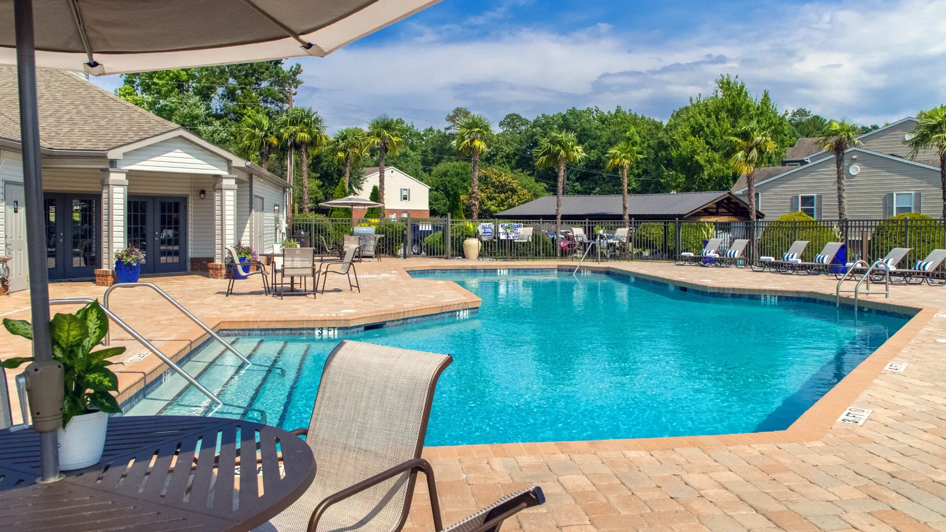 A striking swimming pool surrounded by a sun-soaked sundeck complete with ample poolside loungers for relaxing. 