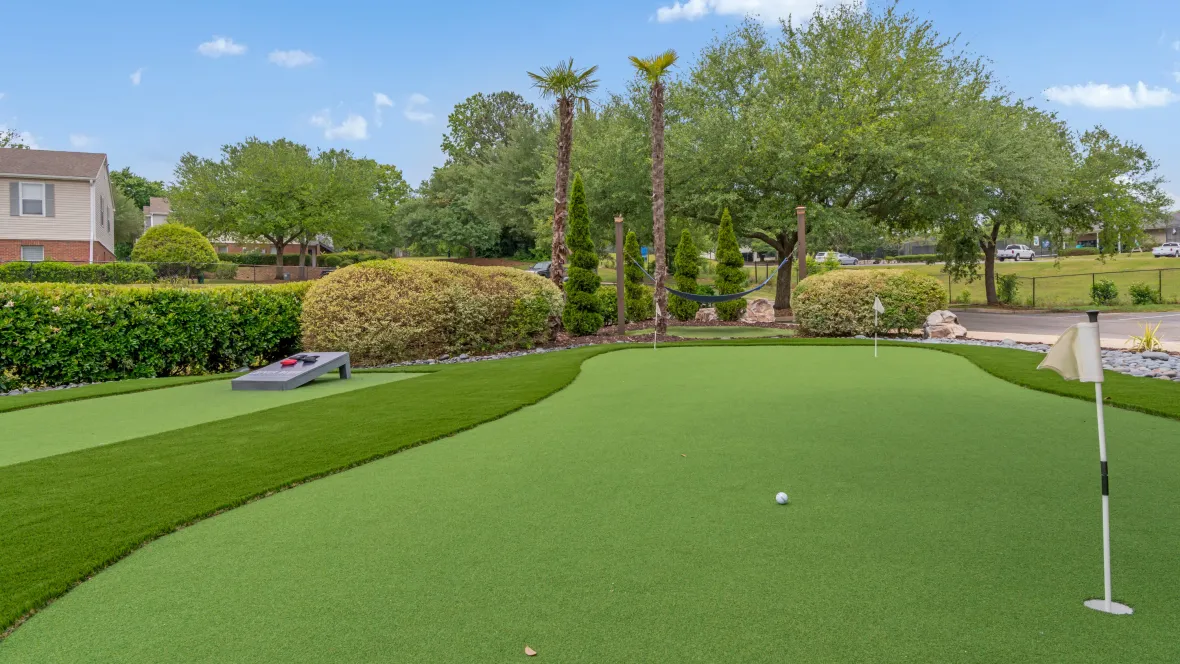 Meticulously manicured putting green, an outdoor amenity that adds charm to the apartment community.